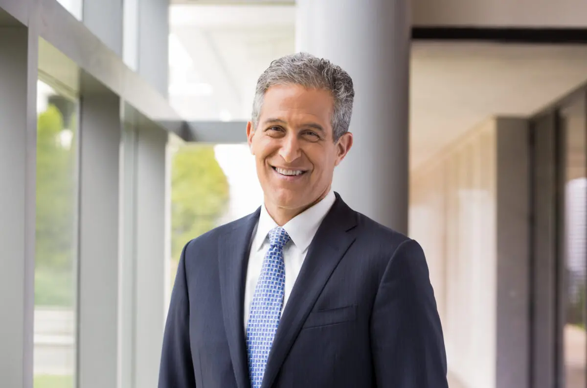 RWJF President & CEO, Dr. Richard Besser standing in a room, smiling