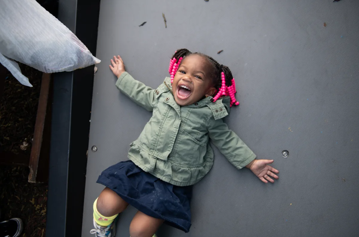 A little girl smiles at the camera